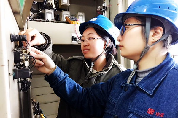 青年女工在师父指导下接编码锁接线.jpg